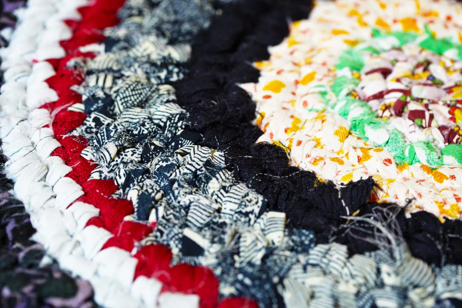 Close-up of a Colonial Mills braided rug showing layered fabric rings and texture